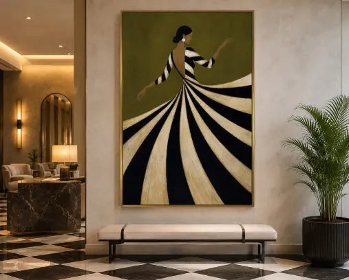 A large framed wall art print hangs in a modern interior lobby. The artwork depicts a woman in a long, dramatic black-and-cream striped gown against an olive green background.